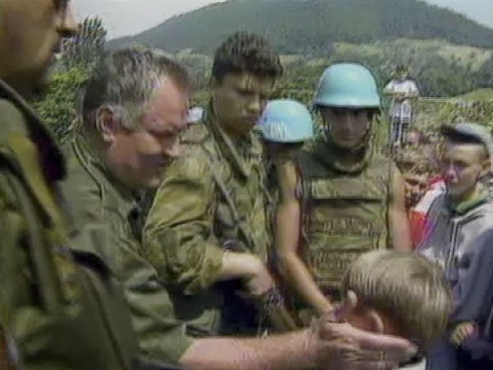 No dia 12 de julho de 1995, Ratko Mladic toca em garoto muçulmano e garante às forças de paz da ONU que a população de Srebrenica estaria segura. Agência AP.